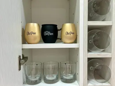 a shelf with cups and glasses on it at Celajes del Poás in Poás