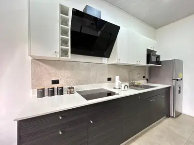 a kitchen with a sink and a refrigerator at Celajes del Poás in Poás
