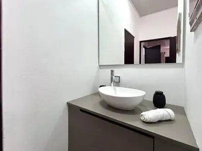 a bathroom with a white sink and a mirror at Celajes del Poás in Poás