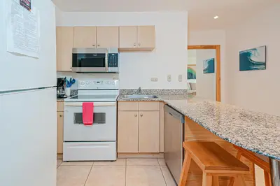 a kitchen with white appliances and a counter top at Palmas de Tamarindo 201D in Tamarindo