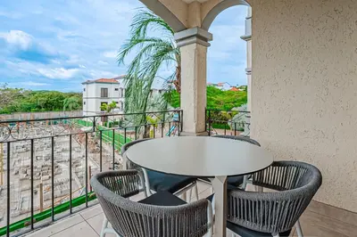 a table and chairs on a balcony with a view at Palmas de Tamarindo 201D in Tamarindo