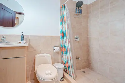 a bathroom with a toilet and a shower at Palmas de Tamarindo 201D in Tamarindo