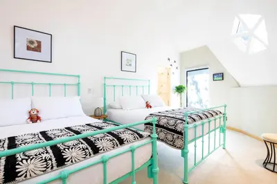 two beds in a room with white walls at Villa San Ignacio in Alajuela City