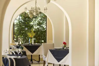 a dining room with tables and a large window at Villa San Ignacio in Alajuela City