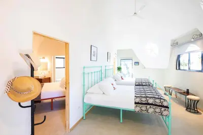a bedroom with a bed and a mirror at Villa San Ignacio in Alajuela City