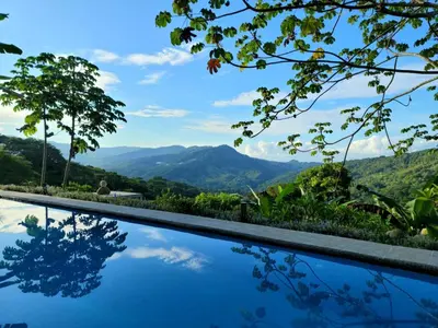 a swimming pool with a view of mountains at Casa Garrobo in Laguna