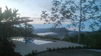 a swimming pool with a view of a mountain at Casa Garrobo in Laguna