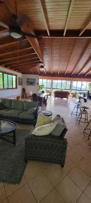 a large living room with couches and tables at Casa Garrobo in Laguna