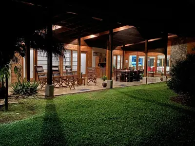 a pavilion with tables and chairs on a lawn at Casa Amanecer Bed & Breakfast in San Ramón