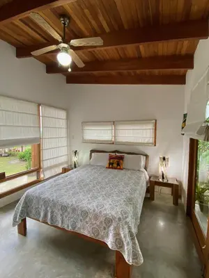 a bedroom with a bed and a ceiling fan at Casa Amanecer Bed & Breakfast in San Ramón