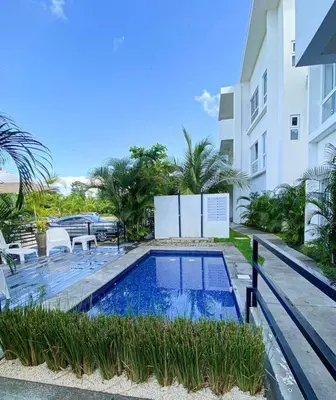 a swimming pool in front of a building at Modern & convenient condo in Jaco downtown in Jacó