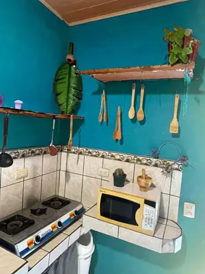 a toy kitchen with a stove and a microwave at Surf House in Sámara