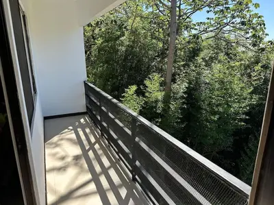 a balcony of a house with a view of trees at Casa mirando a la montaña, camino al volcán in Alajuela City