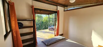 a bedroom with a bunk bed and a door to a balcony at Casa de campo rodeada de naturaleza in San Francisco