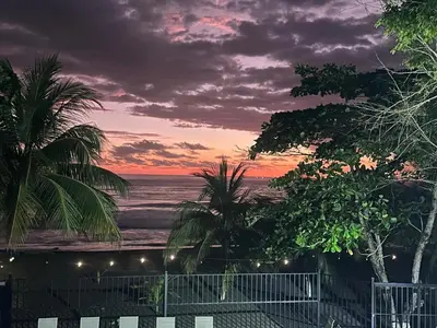 a view of the ocean at sunset from a balcony at BigWave Costa Rica in Playa Hermosa