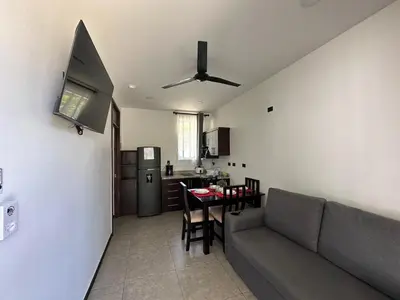 a living room with a couch and a table and a kitchen at BigWave Costa Rica in Playa Hermosa