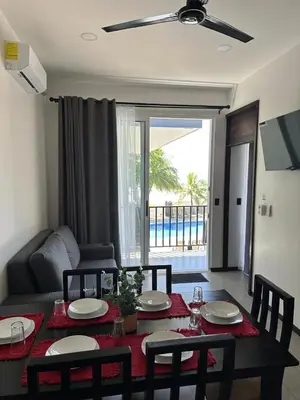 a living room with a table and chairs and a couch at BigWave Costa Rica in Playa Hermosa