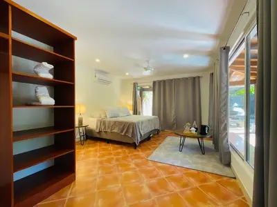 a bedroom with a bed and a table in a room at Casa Spinoza in Playa Negra
