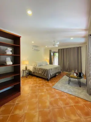 a bedroom with a bed and a table at Casa Spinoza in Playa Negra
