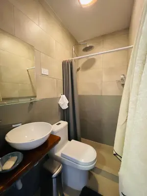 a bathroom with a toilet and a sink and a shower at Casa Spinoza in Playa Negra