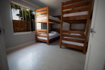 a room with two bunk beds and a window at Beautiful modern house in Nandayure
