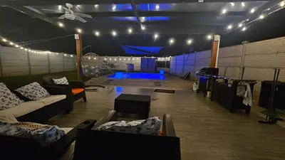 a large living room with couches and a blue pool at Beautiful modern house in Nandayure