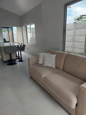a living room with a couch and a table at Beautiful modern house in Nandayure