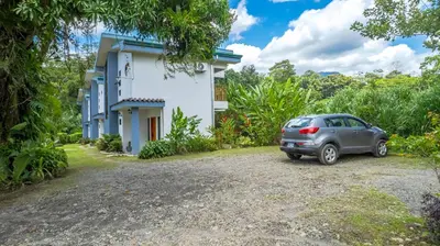 a car parked in front of a house at Villas Sapiens Arenal in Fortuna