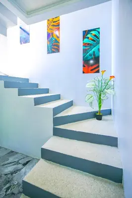 a staircase with a potted plant in a room at Villas Sapiens Arenal in Fortuna