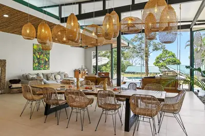 a dining room with a large table and chairs at Pandanus Lodge & Retreats Bungalow Gingiber in Cariblanco
