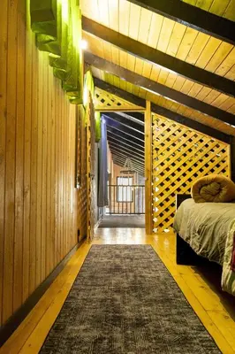 a bedroom with a bed in a room with wooden walls at La Casona de Los Santos in Cedral
