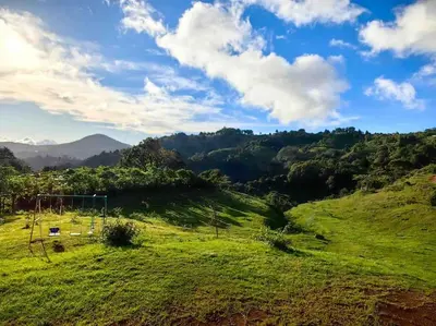 a grassy hill with a soccer field on it at La Casona de Los Santos in Cedral