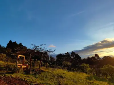 a house on top of a grassy hill at La Casona de Los Santos in Cedral