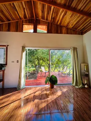 a living room with a large sliding glass door at Ficus house in Boca Tapada