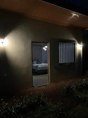 a bedroom with a mirror and a bed in a room at Serenity Mountain in Poás