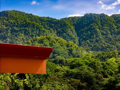an orange bench in front of a mountain at Villa Roca Ocean to Mountain Views - by Pura Villas in Ojochal