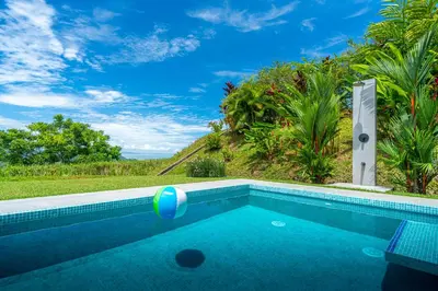 a swimming pool with a beach ball in the middle at Villa Roca Ocean to Mountain Views - by Pura Villas in Ojochal