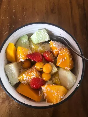a bowl of fruit with a spoon in it at Homestay in Quepos