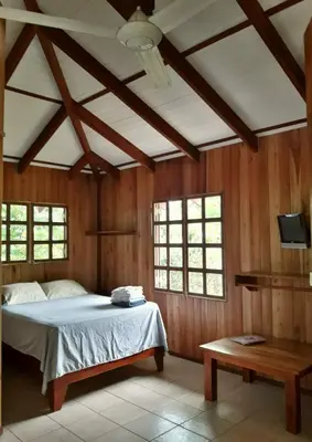 a bedroom with a bed and a table at Las Brisas del Sur in Ojochal