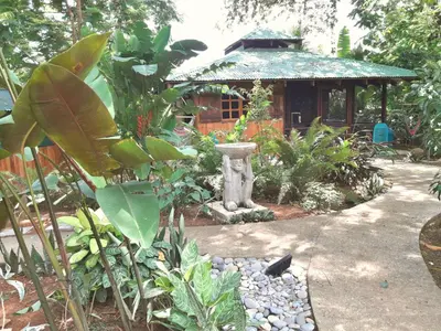 a garden with a fountain and a gazebo at Las Brisas del Sur in Ojochal