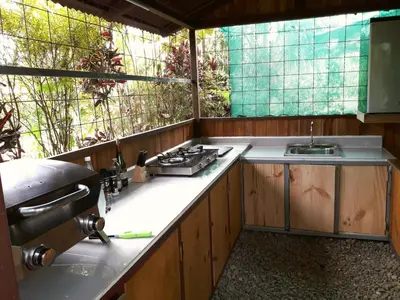 an outdoor kitchen with a stove and a sink at Las Brisas del Sur in Ojochal
