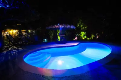 a swimming pool at night with blue lights at Las Brisas del Sur in Ojochal