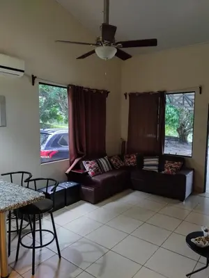 a living room with a couch and a table at Casa Mangos in Orotina