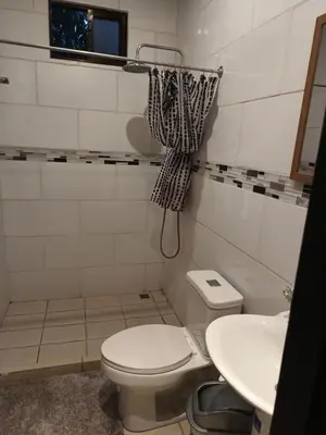 a bathroom with a toilet and a sink at Casa Mangos in Orotina