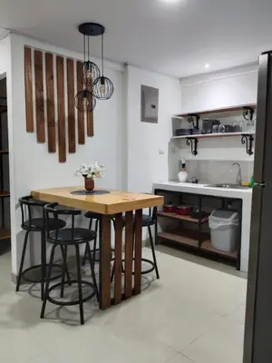 a kitchen with a table and chairs in a kitchen at Cabañas Mantas in Tarcoles