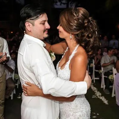a bride and groom hugging each other at their wedding at Hotel Delfin Playa Bejuco in Esterillos Este