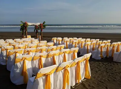 a row of chairs on a beach with the ocean at Hotel Delfin Playa Bejuco in Esterillos Este