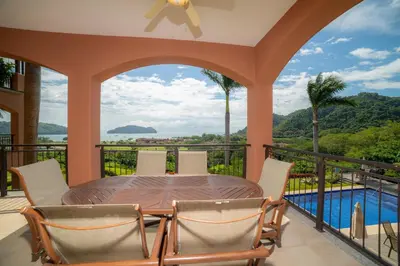 a patio with a table and chairs on a balcony at AltaVista 2C 3 bdr Ocean View in Los Suenos in Herradura