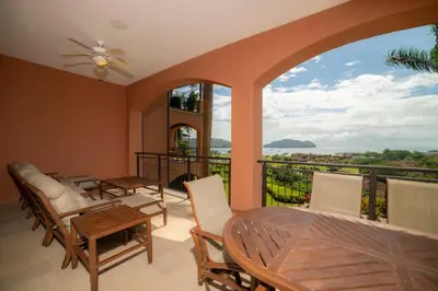 a room with a balcony with a table and chairs at AltaVista 2C 3 bdr Ocean View in Los Suenos in Herradura