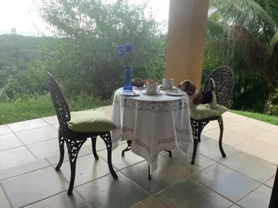 a table with a teddy bear sitting at it at PRIVATE SPACE Just you and the Birds with PRIVATE INFINITY POOL in Uvita